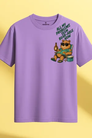 Unisex lavender cotton T-shirt with a cartoon bear in sunglasses holding a drink and the quote "All My Problems Seem Bear-Able Now", regular fit with round neck and short sleeves front view