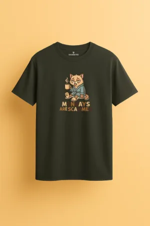 Dark green unisex t-shirt featuring a tired cartoon cat in a robe holding a coffee mug with the phrase “Mondays Are Scammed” in fun typography front view