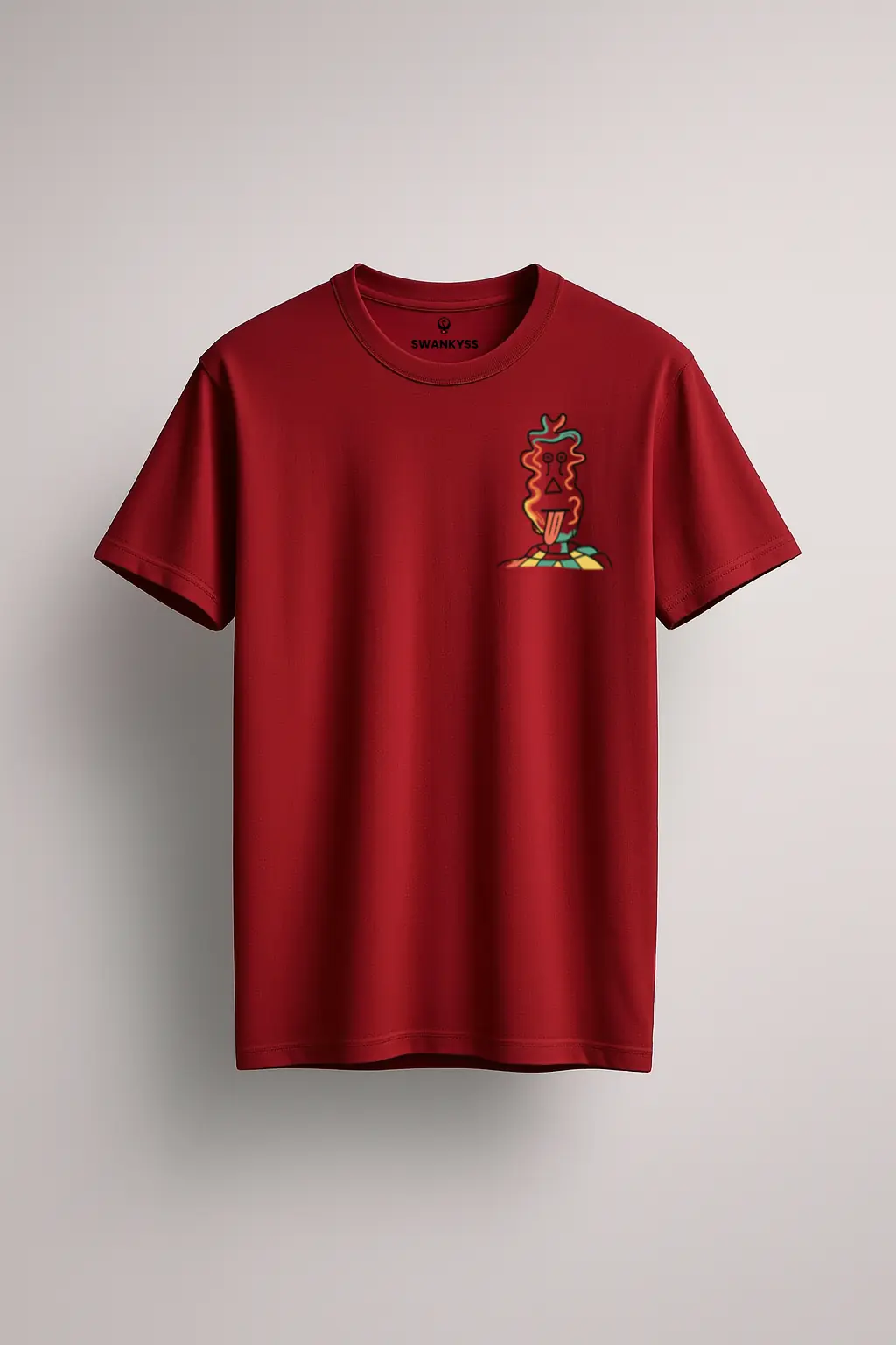 maroon_unisex_tshirt_under_1000kb Maroon unisex t-shirt with a small abstract totem-style character graphic printed on the left chest, standing on a colorful checkered base front view