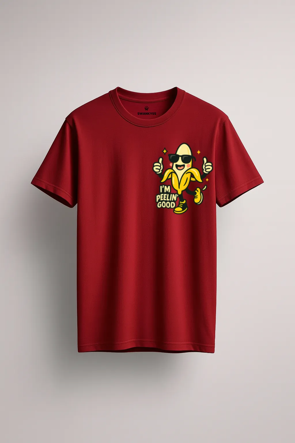 peelin_good_tshirt_under_1000kb Maroon t-shirt with cartoon banana wearing sunglasses and “I’m Peelin’ Good” text – funny fruit graphic tee by Swankyss front view