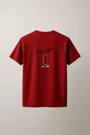 Maroon unisex t-shirt with a small abstract totem-style character graphic printed on the left chest, standing on a colorful checkered base back view