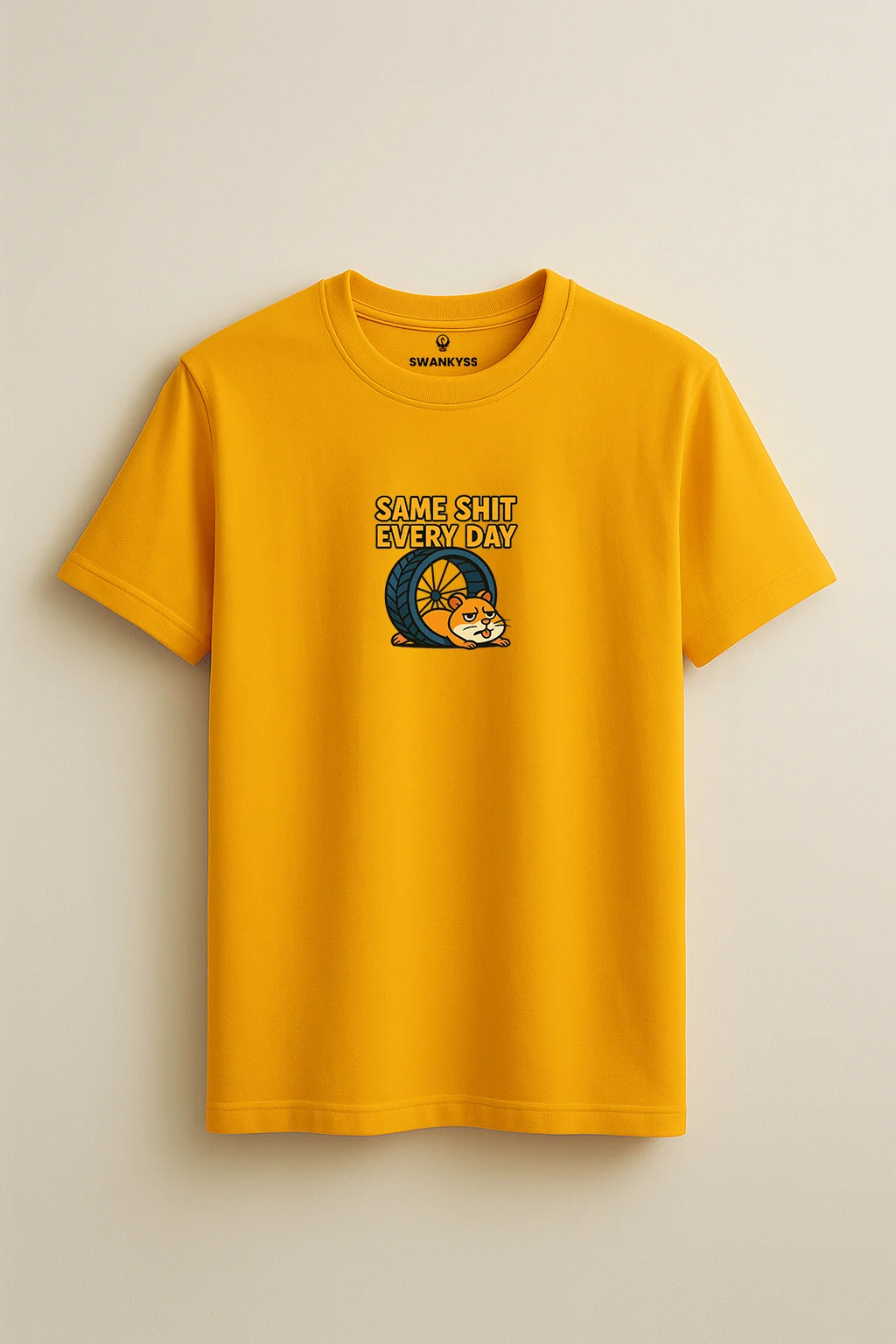 same_every_day_tshirt_under_1000kb Mustard yellow unisex t-shirt featuring a cartoon hamster slumped beside a wheel with the sarcastic phrase “Same Shit Every Day” above it front view