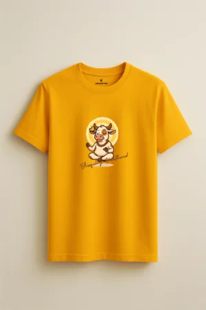 Mustard yellow unisex t-shirt featuring a cartoon cow meditating with prayer beads and a bird on its ear, with the phrase “Blissfully Unbothered” – Swankyss zen graphic tee