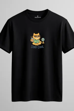 Black unisex t-shirt featuring a cartoon cat in sunglasses and Hawaiian shirt holding a drink next to a fan, with “STAY COOL” text underneath front view